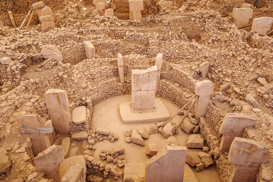 The ancient archaeological site of Göbeklitepe with stone monoliths arranged in a circular pattern, conveying the mysteries of early human construction and culture...