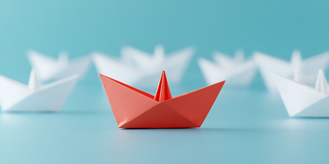 Naklejka premium Bold red paper boat leads the way, guiding a fleet of white ships on a serene blue voyage, embodying leadership and direction, inspiring confidence.