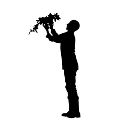 Silhouette of male gardener holding potted plant upward. farming, outdoor gardening scene