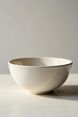 Smooth, matte ceramic bowl on bleached wood, stark background, home decor, clay