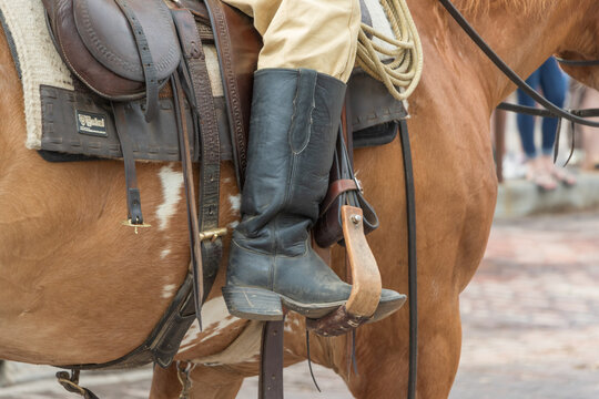 An old west type cowboy boot and saddle with canteen and wouldn't stirrup