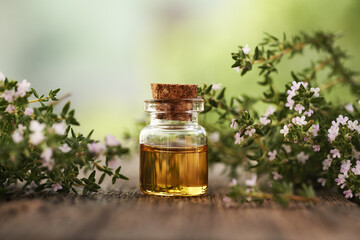 A bottle of thyme essential oil outdoors
