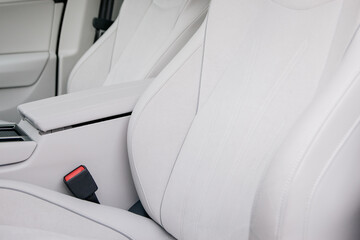 Close up of the luxurious white leather interior of a car highlighting the elegant design and...