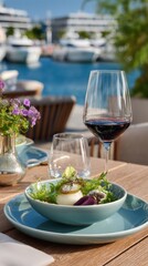 Gourmet salad and red wine pairing on patio overlooking marina and ocean views exquisite fine dining experience luxurious restaurant setting