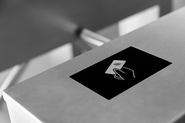RFID card access control system on modern stainless steel turnstile gate in smart office building,...
