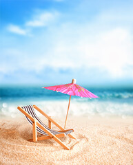 Beach chairs on the gold sand beach with umbrella, cloudy blue sky and sun