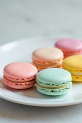 Obraz premium Pastel French macarons, soft focus, white plate, closeup, macarons
