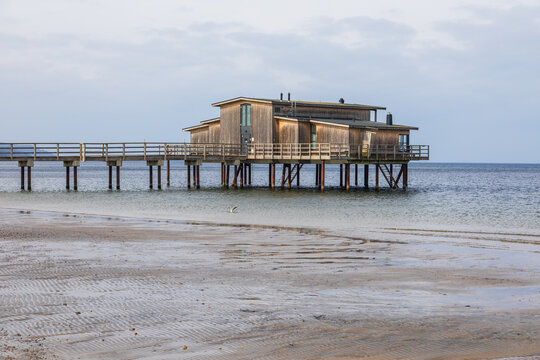 Wooden bathhouse on stilts over the sea in Torekov, Sweden.