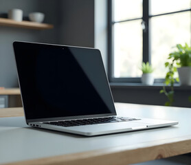 Fototapeta premium A modern, minimalist tech lab bench with an empty space on a sleek, frosted glass surface next to an open laptop screen displaying a black desktop background. Soft, diffused overhead lighting creates 
