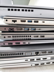 stack of laptops on a gray background, on the table, laptop computer, tablet, business, work, remote work, freelance