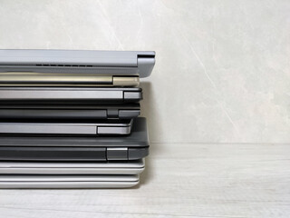 stack of laptops on a gray background, on the table, laptop computer, tablet, business, work,...