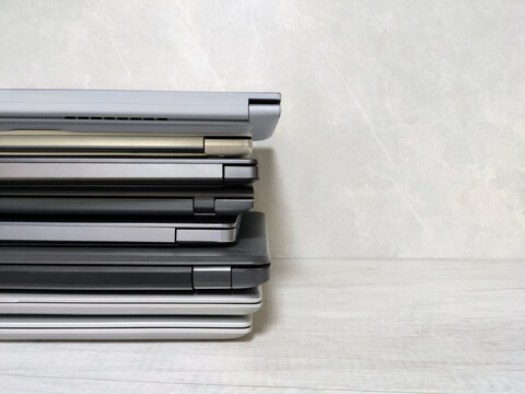 stack of laptops on a gray background, on the table, laptop computer, tablet, business, work, remote work, freelance