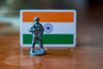 A tin soldier on the background of the Indian flag. India Pakistan military conflict