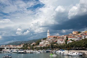 coastal village harbor with boats and church tower
