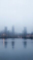 Urban silhouettes shrouded in atmospheric haze with water reflections