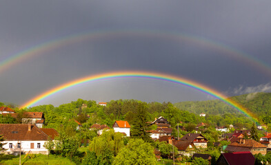 A spectacular landscape with a rainbow over a rural village
