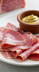 Sliced ham served with mustard on the side, gourmet presentation 