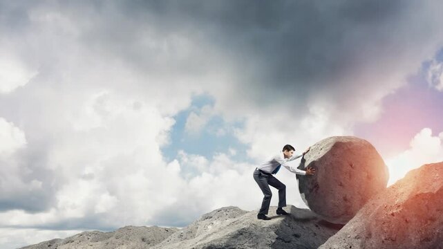 Businessman pushing large rock uphill, overcoming obstacles, inspiring image, for motivation, business, or leadership