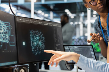 Close up of manager supervising admin using computer in data center office, integrating AI driven...