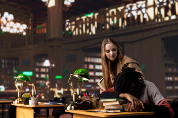 Person waking up african american girl in the university campus library, student falling asleep on...
