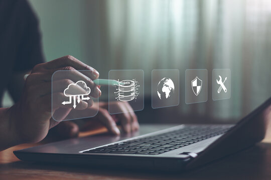 Disaster recovery concept. Information technology system protection. Person using a laptop with a disaster recovery icon on a virtual screen. Transfer file business data backup to the cloud system.