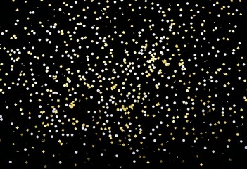 a black background with gold confetti