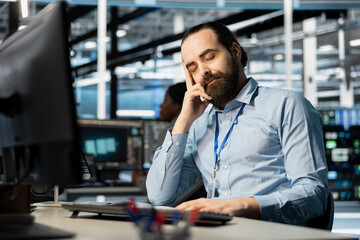 Exhausted server hub worker falling asleep at desk after repeated debugging attempts. Tired technician in data center sleeping in office after long hardware troubleshooting session