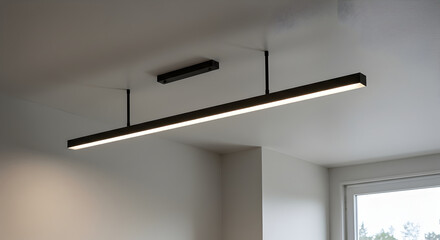 Minimalist Linear Lighting Fixture Suspended From Ceiling In Modern Interior