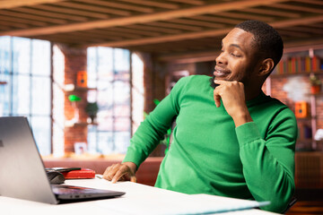 Freelancer in home office sitting at desk and typing on laptop keyboard. Remote employee using...