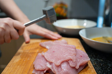 Tenderize meat, beating, hammering fillet pieces, cooking schnitzel process closeup