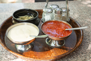 Vietnamese sauces set on the table in a street restaurant closeup. Mayonnaise, garlic dressing