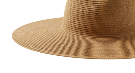 A close up view of a tan straw hat with a wide brim on a black background showing texture details