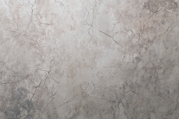Obraz premium Gray textured background with cracks, offering a rustic and aged appearance suitable for various design projects, including website banners or wallpapers