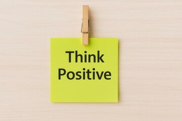 A bright yellow sticky note with the message "Think Positive," encouraging an optimistic mindset for a successful and happy life