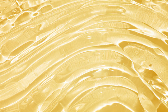 Cream gel yellow orange retinol or vitamin c transparent cosmetic sample texture with bubbles background