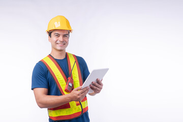 Handsome confident young craftsman wear yellow helmet hard hat safety with walkie talkie holding tablet standing over isolated white background. Maintenance workman occupation technology concept.