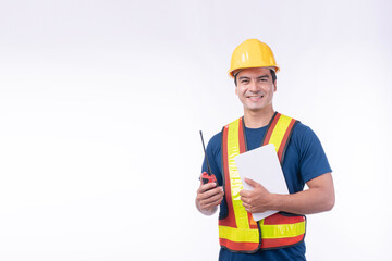 Maintenance workman occupation technology concept. Handsome confident craftsman wear yellow helmet hard hat safety talking with walkie talkie while looking tablet standing over isolated background.
