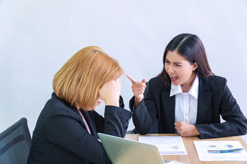 Stress businesswomen suit with boss pointing finger yelling reprove argument sitting on table...