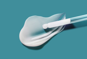 Pipette serum texture white swatch sample on light cian blue background. Cosmetic beauty skin care product moisturizer
