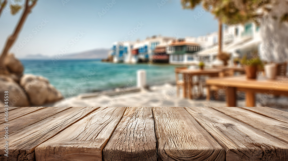 Poster an empty wooden tabletop with a blurry view of a coastal cafe and the coastline of a gorgeous greek 