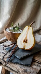 Rustic still life with pear, coconut, vanilla pods on wooden plank