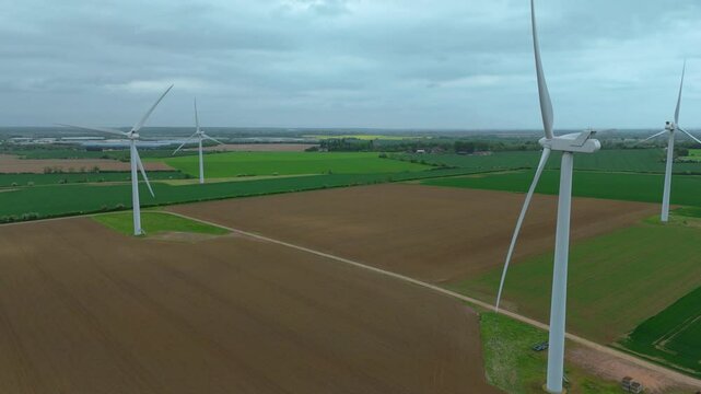 Aerial drone view renewables wind turbines energy electricity gas coal fossil fuels green rural fields generation England UK Biggleswade 