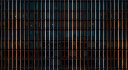 Building fa&ccedil;ade with a grid of windows or colored panels 