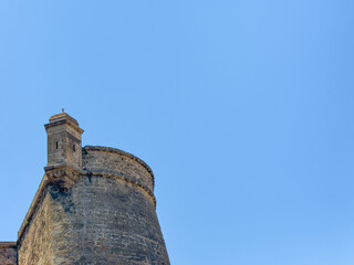 Principality of Monaco, France - July 9, 2024: Palace. Top of ramparts tower with small lookout turret shelter against blue sky