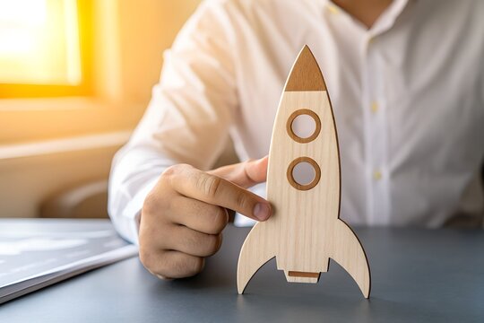 Rocket Launch and Business Innovation: a person is shown ready to launch a wooden rocket, symbolizing business innovation and success in a strategic startup.