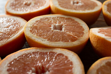 A closeup view of a layer of grapefruit slices, as a background.