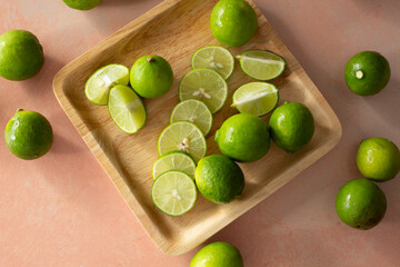 A top down view of a plate of sliced key limes.