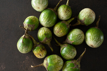 A top down view of a pile of Thai eggplant.