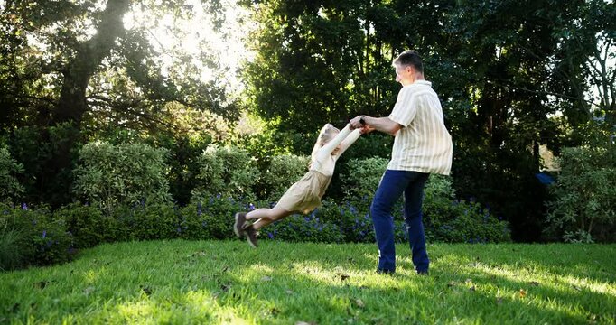Father, girl and play with spin in backyard, holding hands and happy for bonding with love in summer. People, dad and child with flight, game and connection for care in family garden on lawn in Spain
