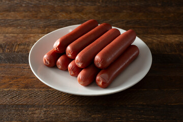 A view of a pile of turkey hot dogs on a plate.